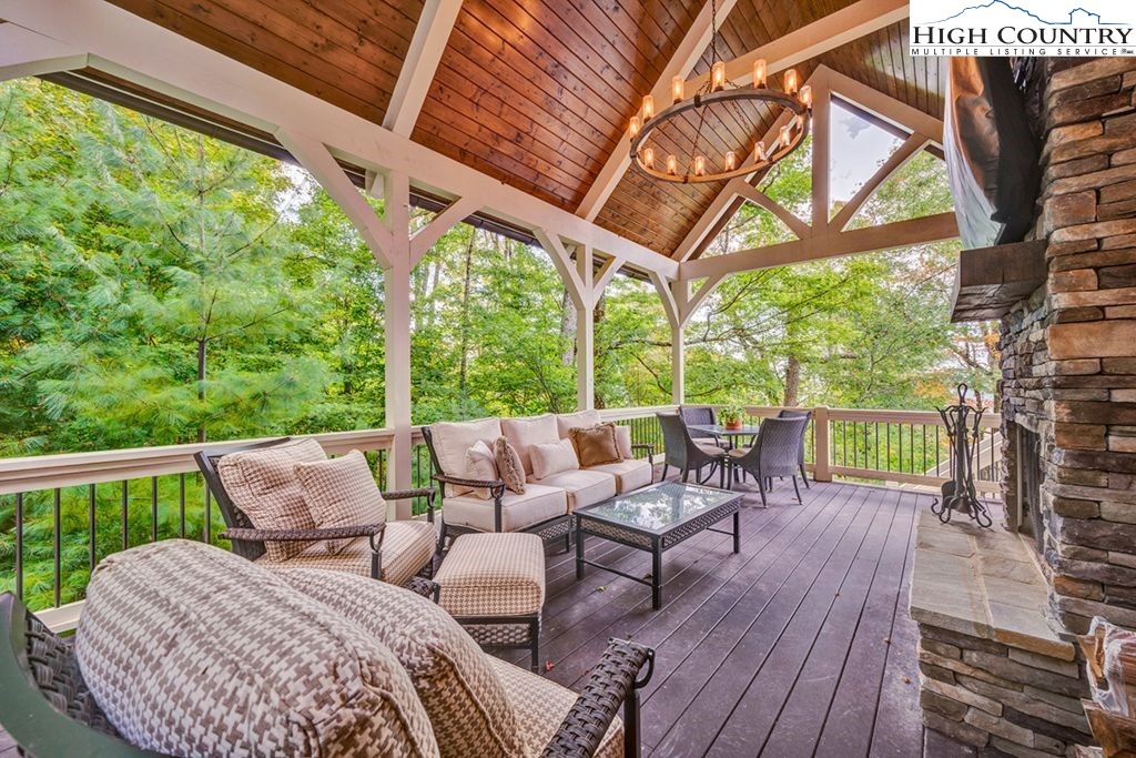 906 Fox Meadow Road Banner Elk, NC 28604 - Photo 5 of 40 a view of a patio with a table chairs and a backyard
