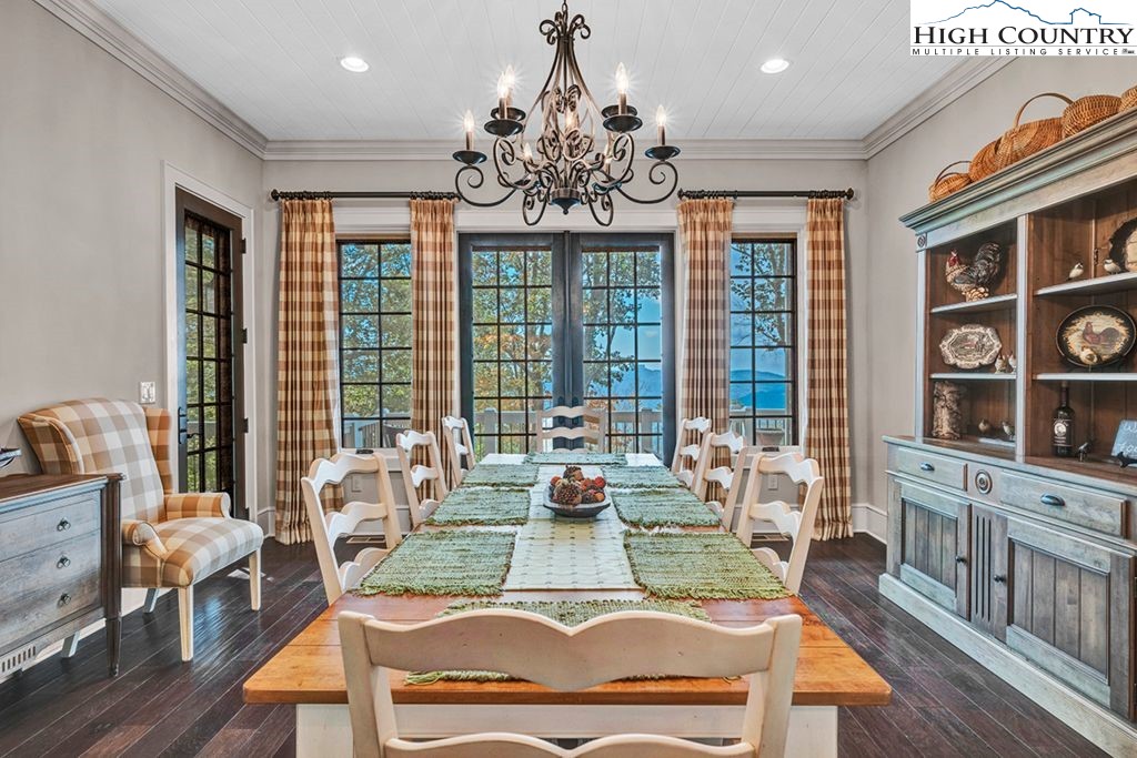 906 Fox Meadow Road Banner Elk, NC 28604 - Photo 10 of 40 a living room with fireplace furniture and a chandelier