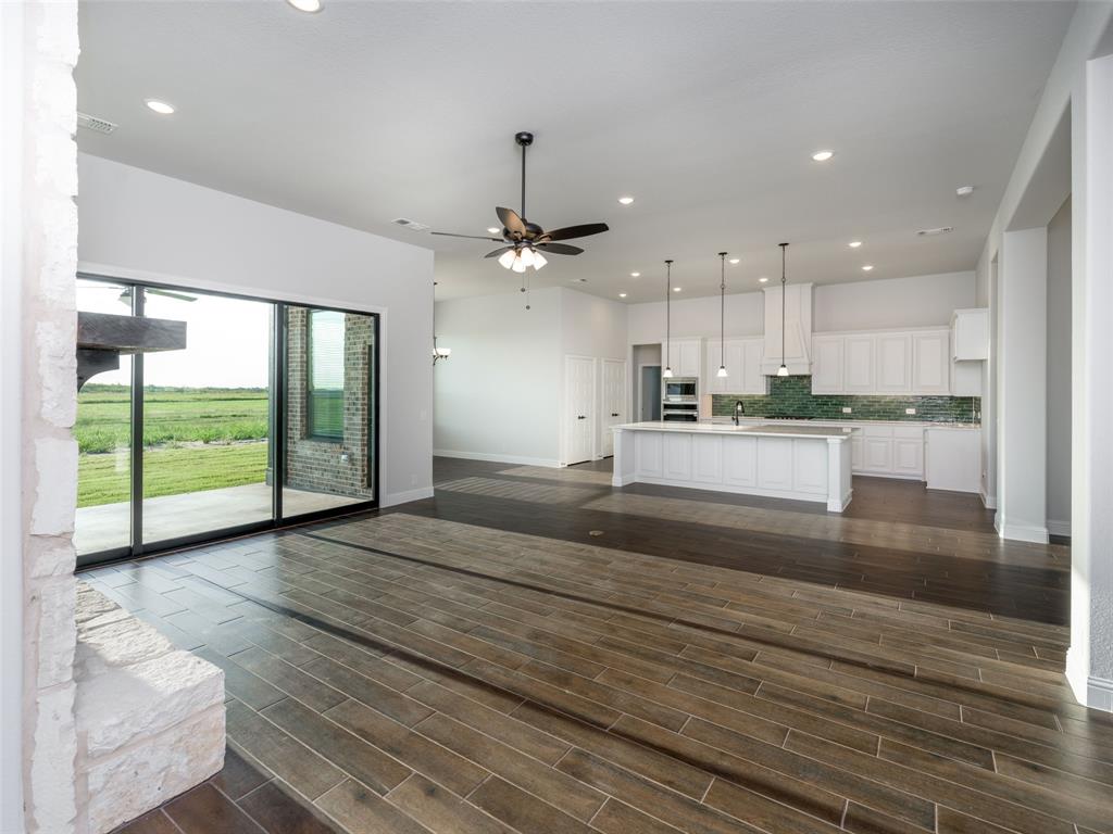 2108 Charters Circle Nevada, TX 75173 - Photo 35 of 37 Kitchen featuring tasteful backsplash, white cabinetry, recessed lighting, open floor plan, and decorative light fixtures