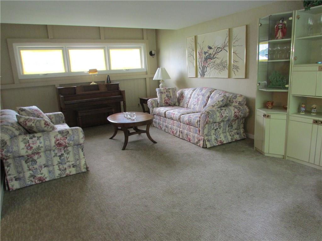 1765 Partridge Run Road Upper St. Clair, PA 15241 - Photo 11 of 25 LIVING ROOM - Stained glass windows are hard to see in this photo from the bright light, but in person, they bring a soft glow to the room.