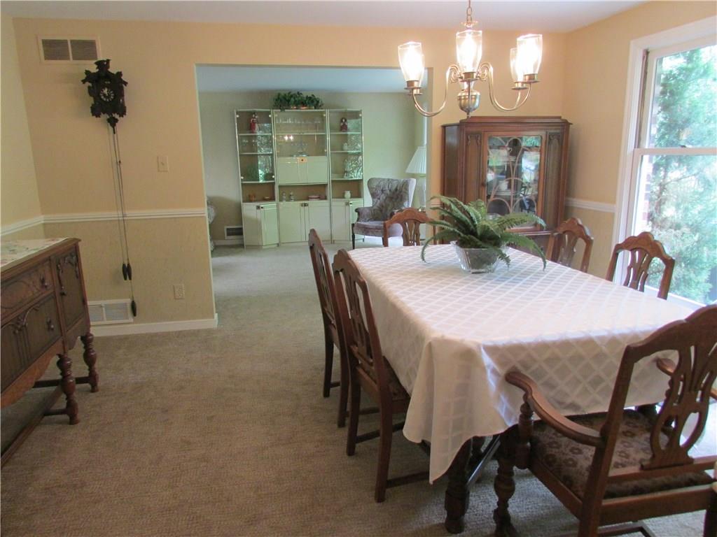 DINING ROOM - The dining room accommodates many large pieces of furniture. Large windows bring in lots of light.