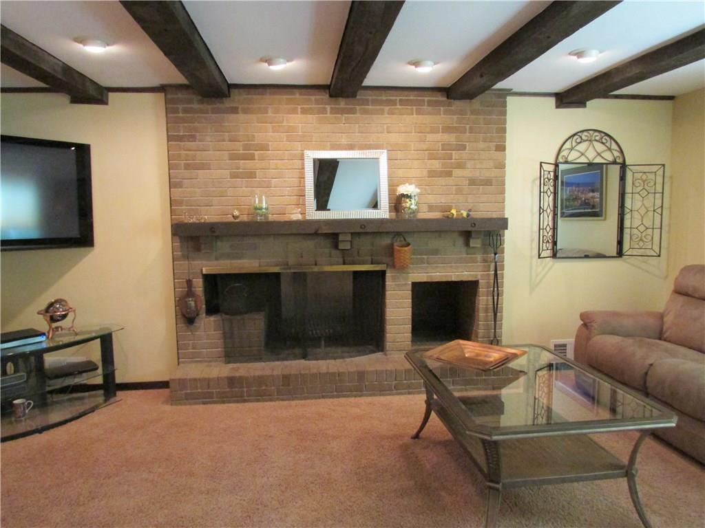 1765 Partridge Run Road Upper St. Clair, PA 15241 - Photo 8 of 25 FAMILY ROOM - Log burning fireplace has a built-in area for wood. Wooden beams accent the ceiling.
