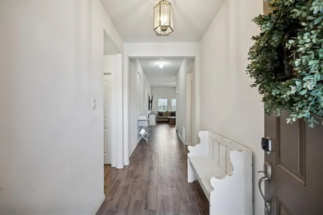 a view of a hallway view with wooden floor and staircase