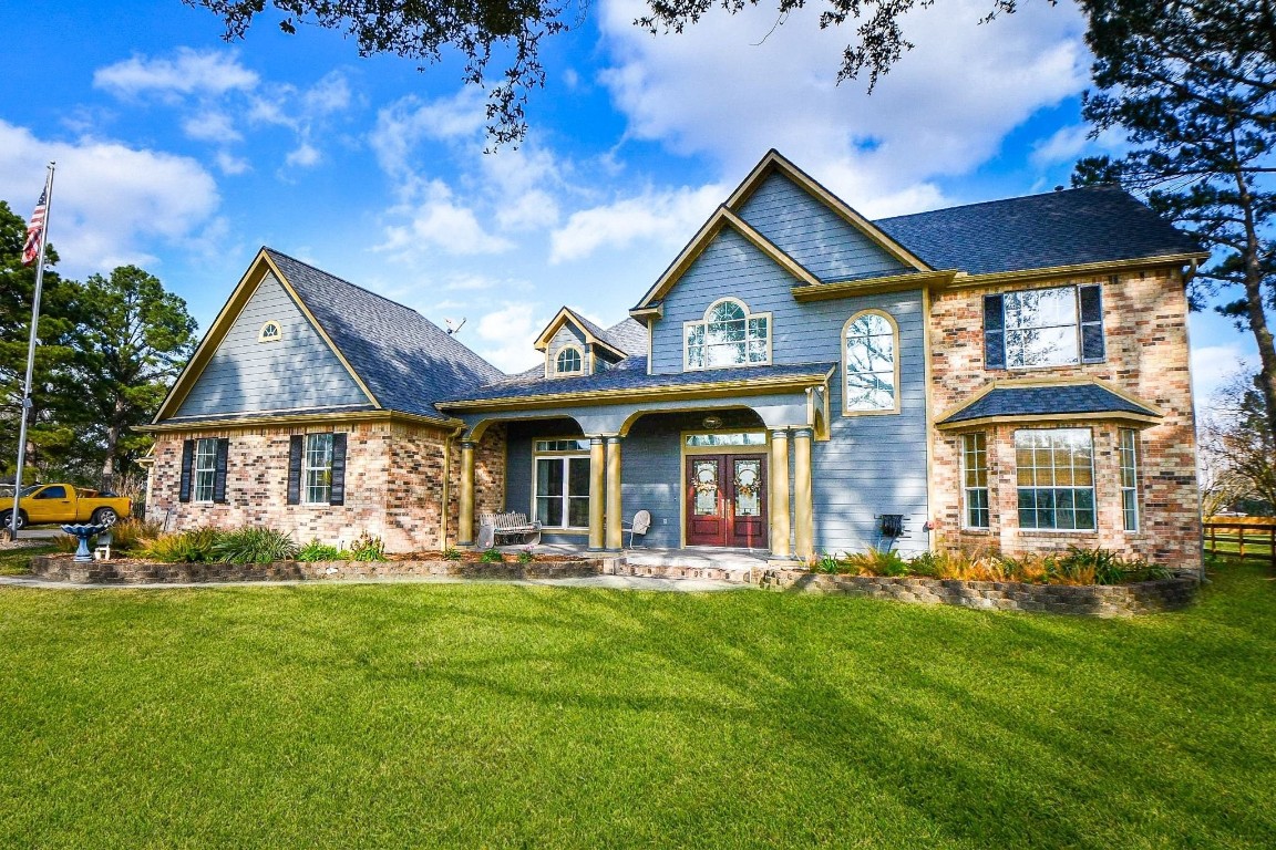 This magnificent 2-story brick gem with covered front porch/entrance, offers peace and solitude in nature's grove!