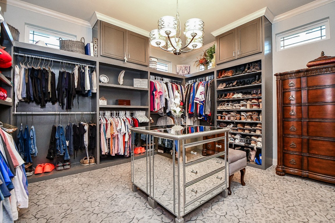 3680 Eula Morgan Road Katy, TX 77493 - Photo 16 of 50 Oh my! This spectacular primary walk-in closet does outstanding double duty --- as a charming storage/organizing spot; but also as a magazine/museum worthy space; with darling rectangular windows way up high, cabinetry, shelving and hanging rods, with room for a gorgeous dresser/jewelry station, smack dab center.