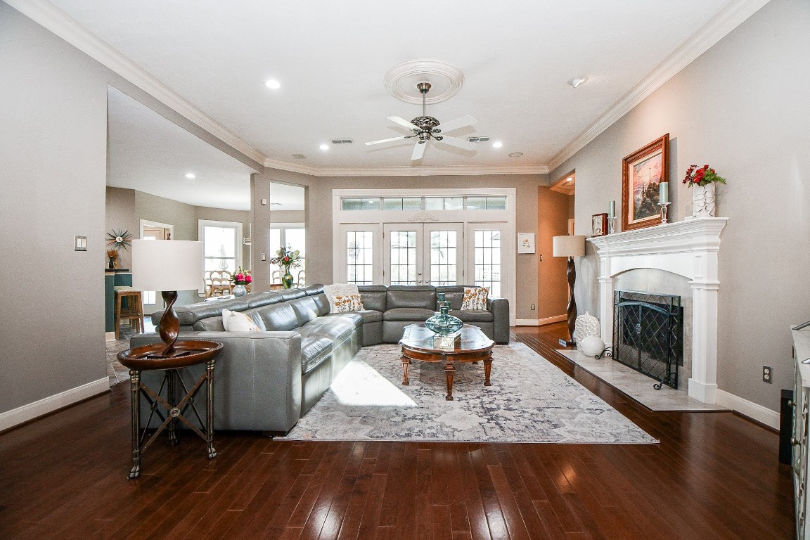 3680 Eula Morgan Road Katy, TX 77493 - Photo 7 of 50 Streamlined features define the contemporary charm of this bright living/family area, which welcomes casual, oversized seating, a marvelous built-in fireplace (right), double pairs of patio doors, up center, high ceiling, with gourmet kitchen, left.