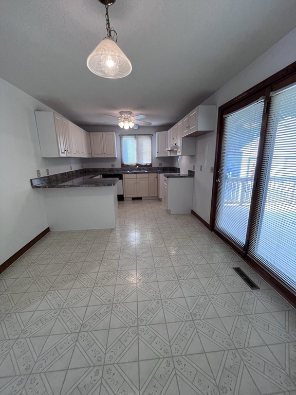 48 Peekskill Avenue Springfield, MA 01129 - Photo 5 of 23 a kitchen with kitchen island granite countertop a sink cabinets and window