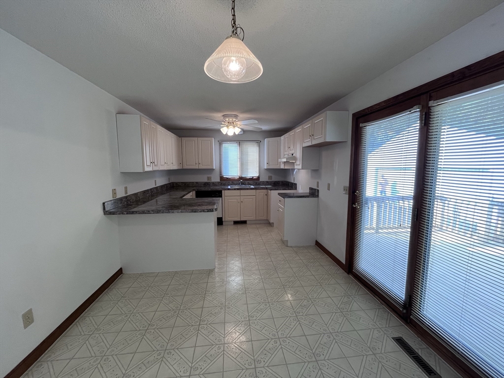 48 Peekskill Avenue Springfield, MA 01129 - Photo 6 of 23 a kitchen with stainless steel appliances granite countertop a refrigerator and a stove top oven