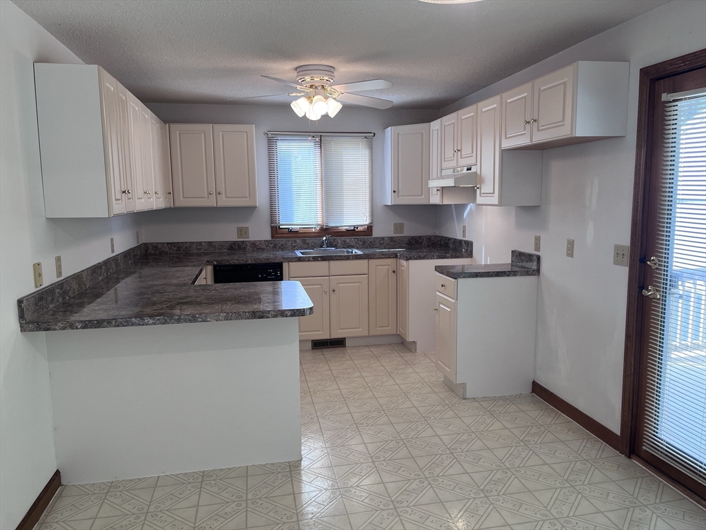 48 Peekskill Avenue Springfield, MA 01129 - Photo 7 of 23 a kitchen with stainless steel appliances granite countertop a stove a sink and a refrigerator