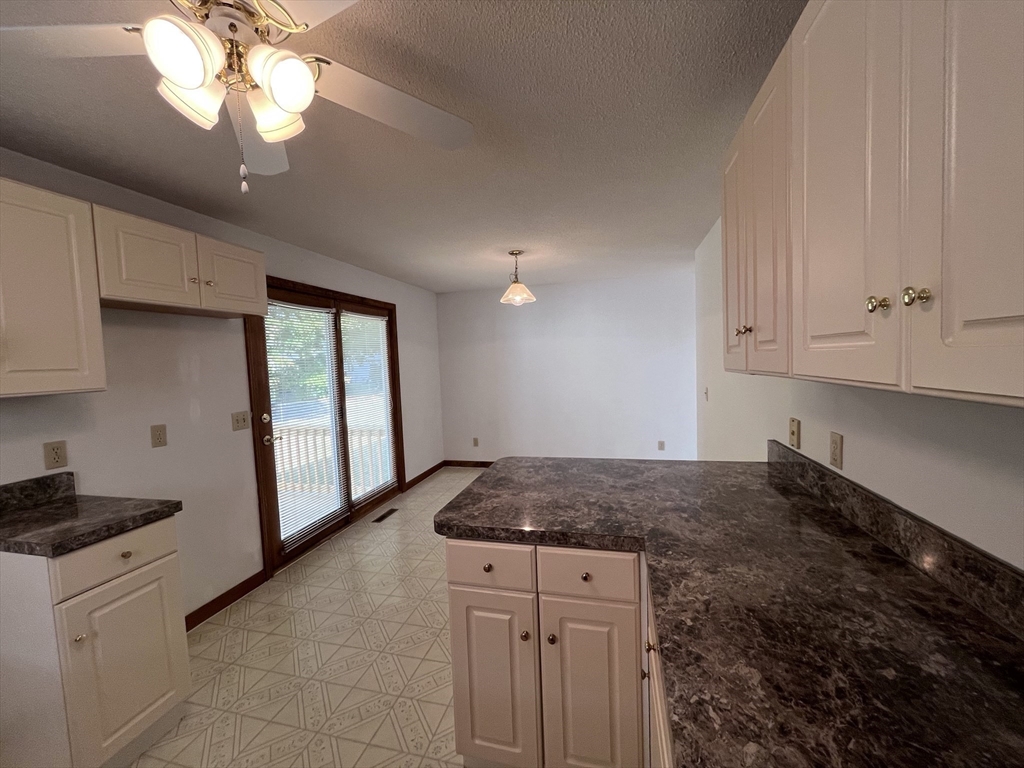 48 Peekskill Avenue Springfield, MA 01129 - Photo 8 of 23 a kitchen with a sink granite counter tops and a stove