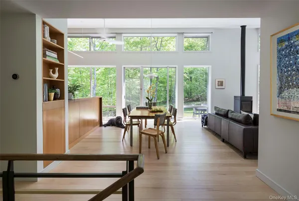a dining room with furniture window and wooden floor