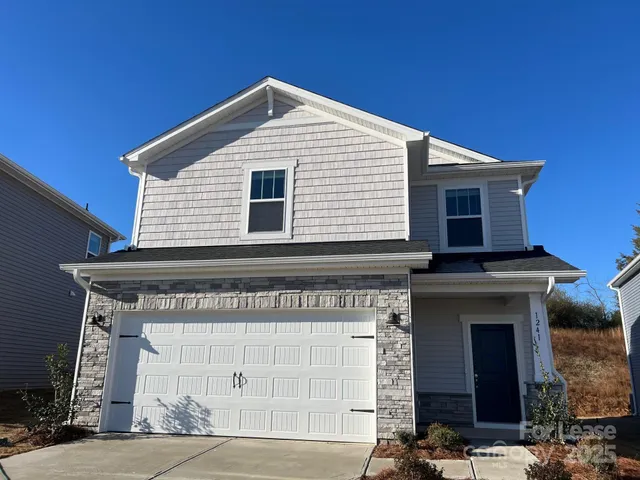a front view of a house with a garage