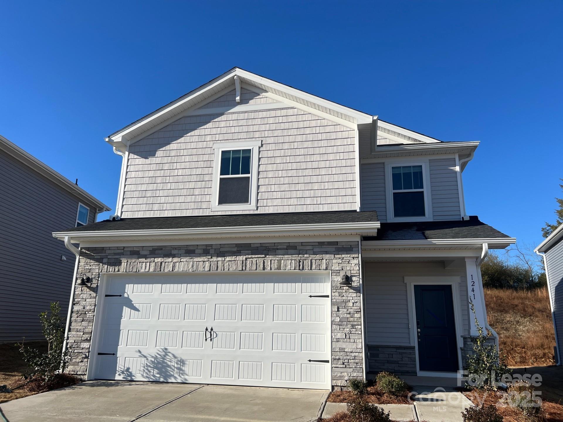a front view of a house with a garage
