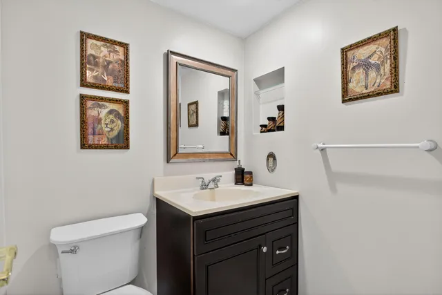 a bathroom with a sink mirror and toilet