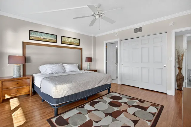 a bedroom with a bed and a table with wooden floor