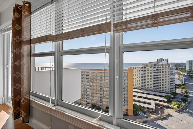 a view of a balcony with floor to ceiling windows