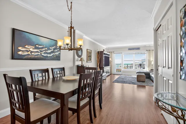 a view of a dining room with furniture wooden floor and a chandelier