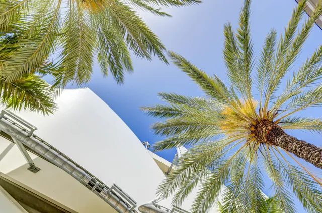 a blue swimming pool with a outdoor seating