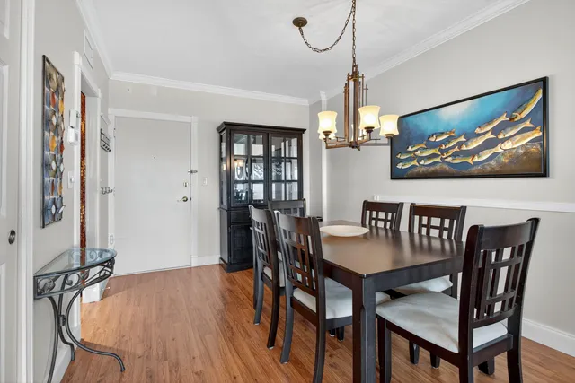 a view of a dining room with furniture window and wooden floor
