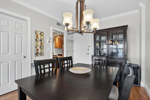 a view of a a dining room with furniture window and wooden floor