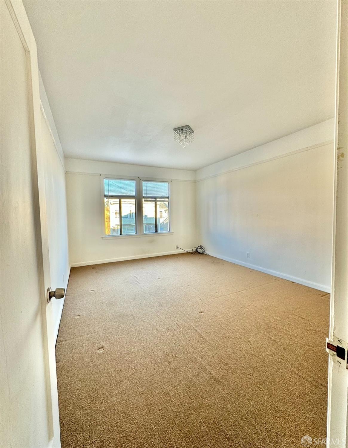 247 Brighton Avenue San Francisco, CA 94112 - Photo 2 of 11 an empty room with windows