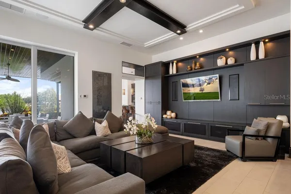 a view of a workspace with furniture and a flat screen tv