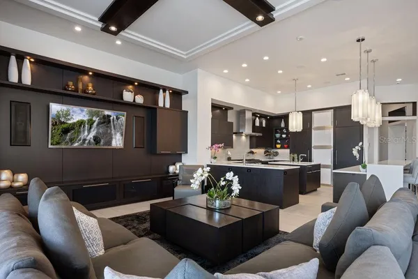 a living room with furniture and a floor to ceiling window