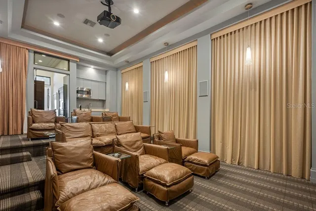 a living room with furniture and a floor to ceiling window