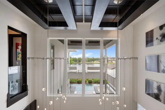 a view of a patio with couches and chairs under an umbrella