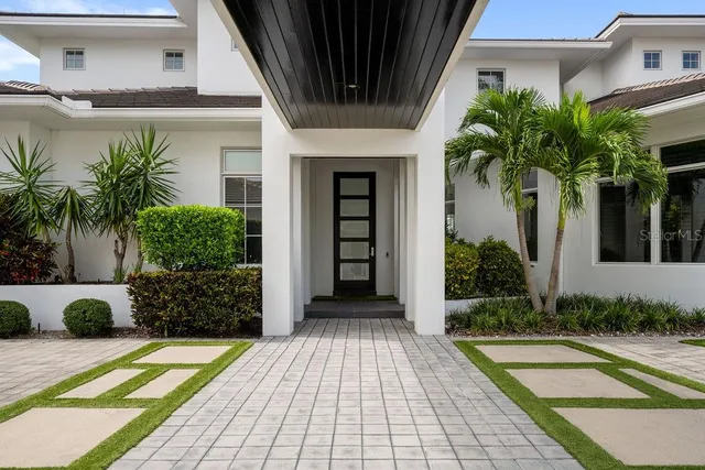 a view of a house with a yard patio and swimming pool