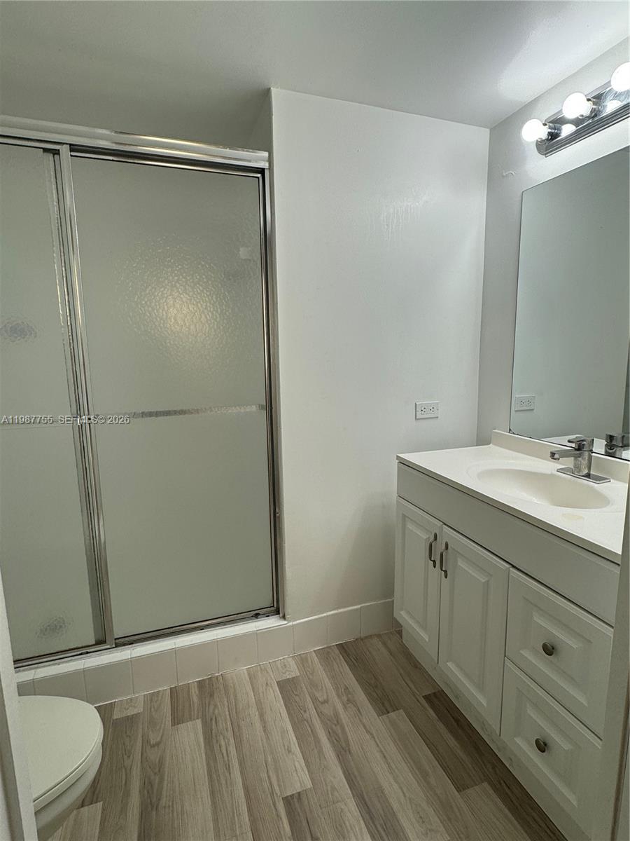 2071 Renaissance Boulevard, Unit 104 Miramar, FL 33025 - Photo 13 of 17 a bathroom with a granite countertop sink toilet and shower