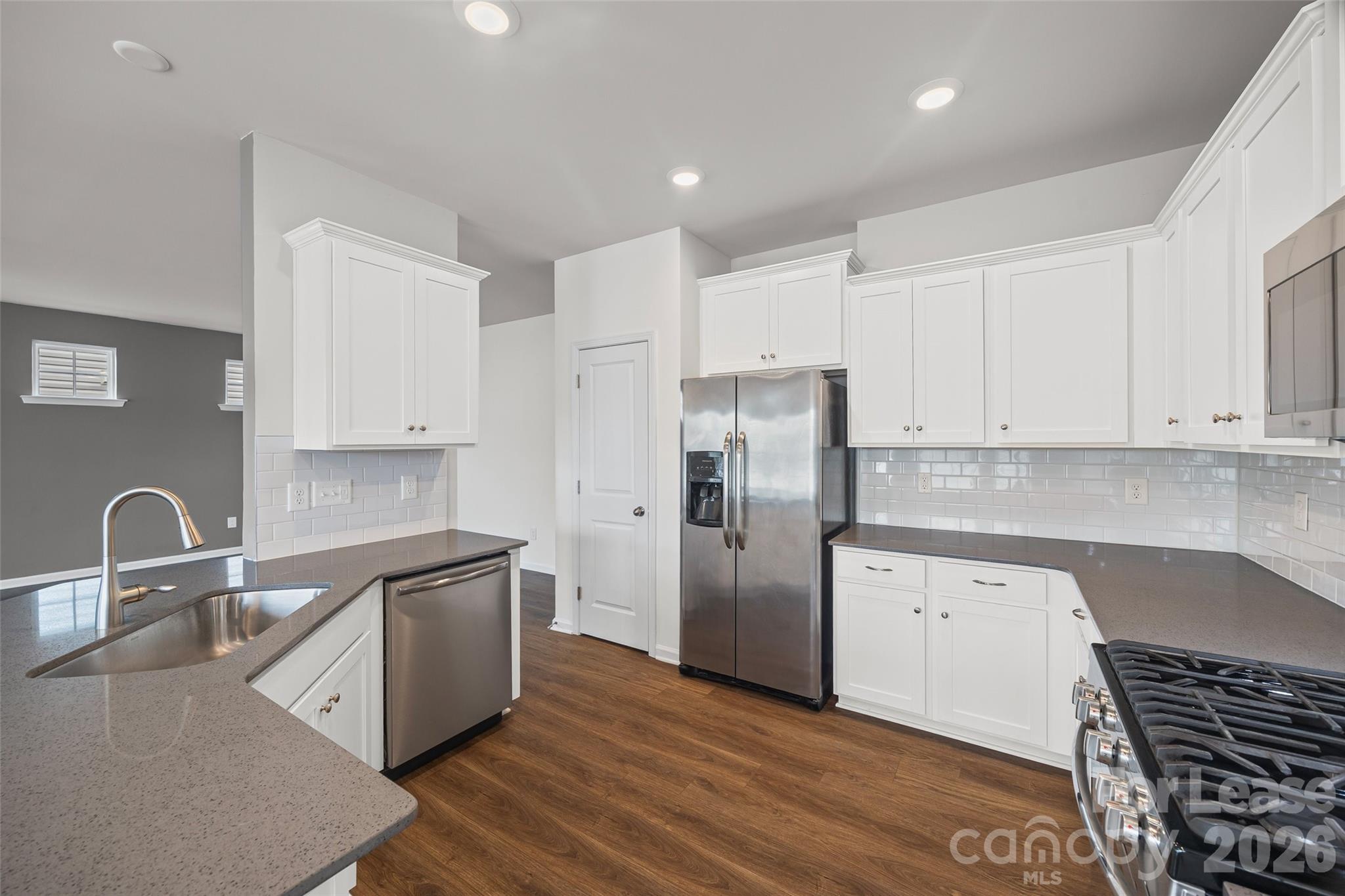 5775 Soft Shell Drive Lancaster, SC 29720 - Photo 14 of 40 a kitchen with stainless steel appliances a refrigerator sink and cabinets