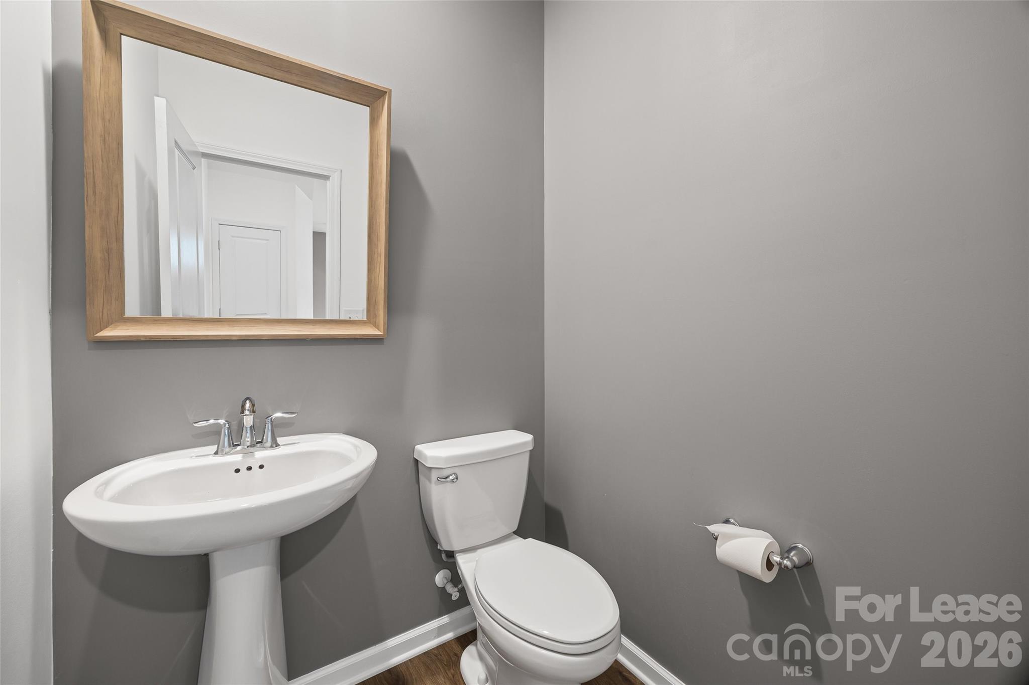 5775 Soft Shell Drive Lancaster, SC 29720 - Photo 18 of 40 a bathroom with a toilet a sink and mirror