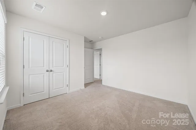 a view of a terrace with lawn chairs