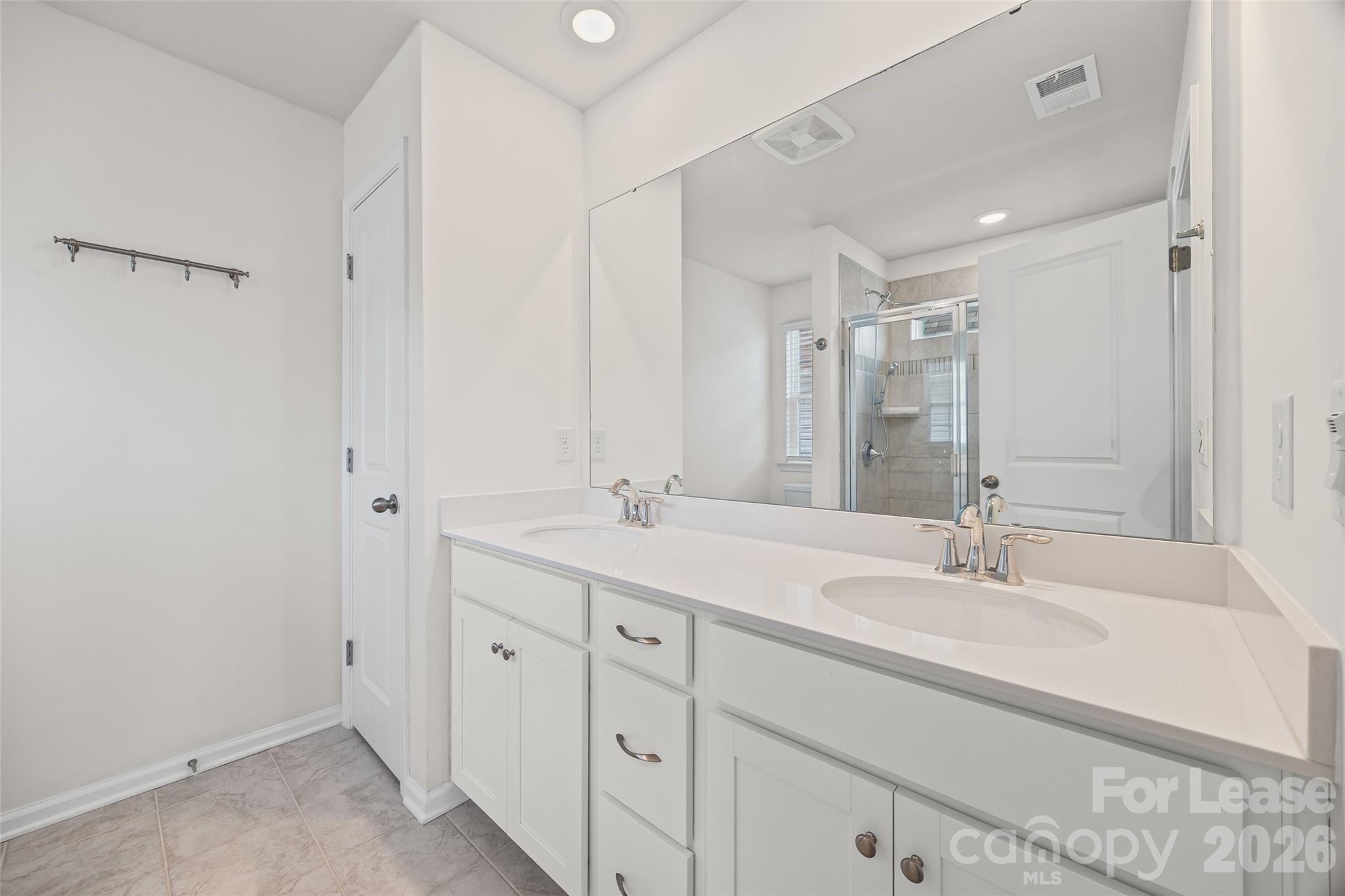 5775 Soft Shell Drive Lancaster, SC 29720 - Photo 31 of 40 a bathroom with double sink and a mirror