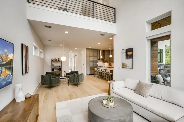 a living room with furniture and kitchen view