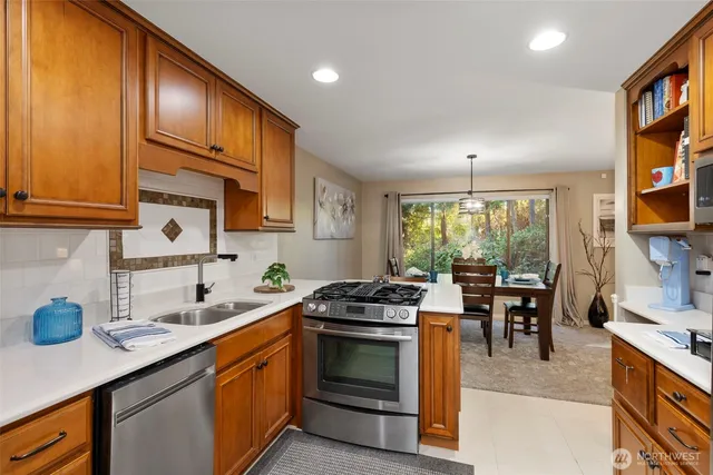 a kitchen with a stove a sink and cabinets