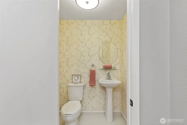 a white toilet sitting next to a small bathroom