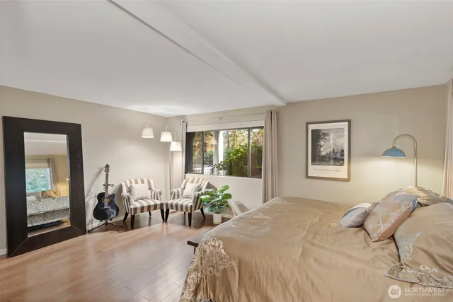 a bedroom with a bed and glass windows