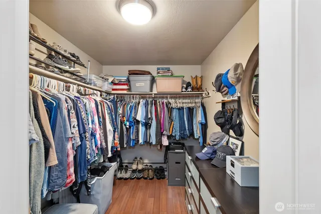 a view of walk in closet with clothes