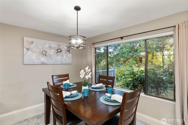 a view of a dining room with furniture large windows and wooden floor