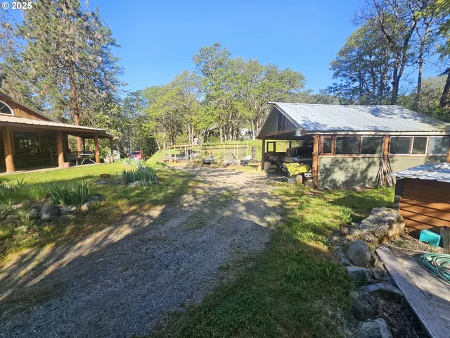 a view of a house with backyard and sitting area