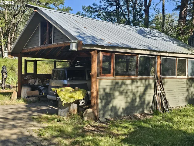 a porch with a glass top table and chairs