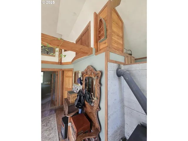 a view of a hallway and a livingroom with furniture
