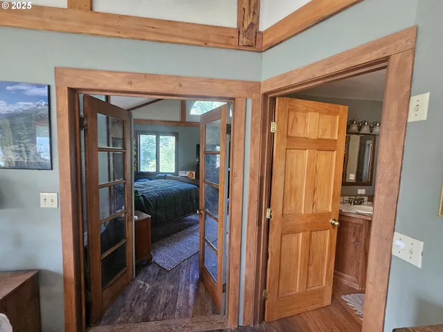 a bedroom with a bed couch tv and a window