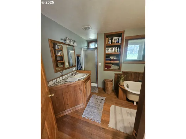 a bathroom with a sink mirror and a bath tub