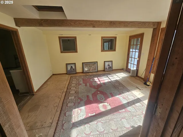 a view of an entryway with a floor to ceiling window and a living room