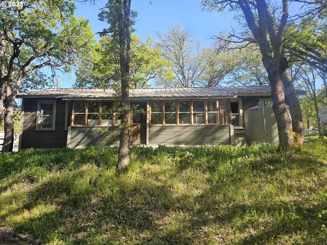 a backyard of a house with table and chairs