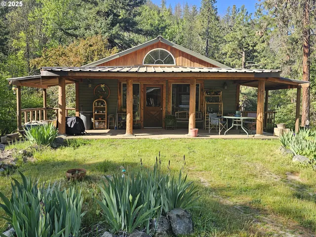 a view of a front of a house with a large window and plants