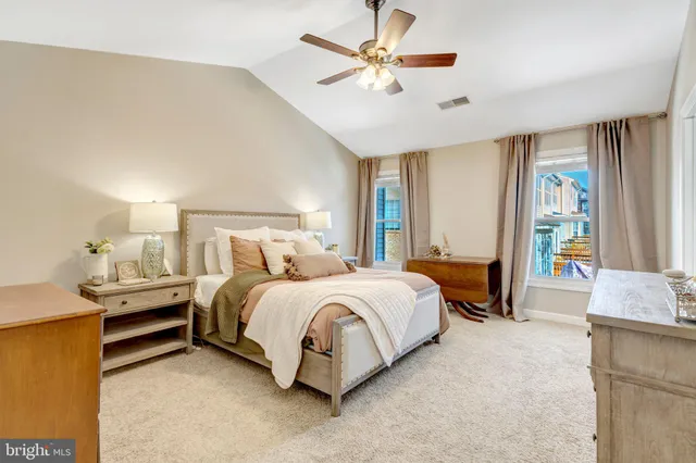 a spacious bedroom with a bed and a chandelier